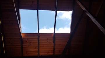 Skylight opening framed into a timber-lined ceiling